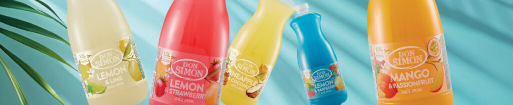 Five colorful Don Simon juice bottles—Lemon & Lime, Lemon & Strawberry, Orange & Pineapple, Blue Lagoon, and Mango & Passionfruit—stand against a light blue background with a green palm leaf on the left.